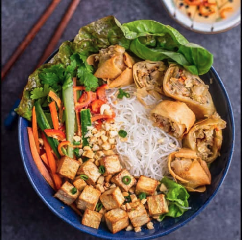 Fresh Vietnamese noodle bowl with tofu and spring rolls